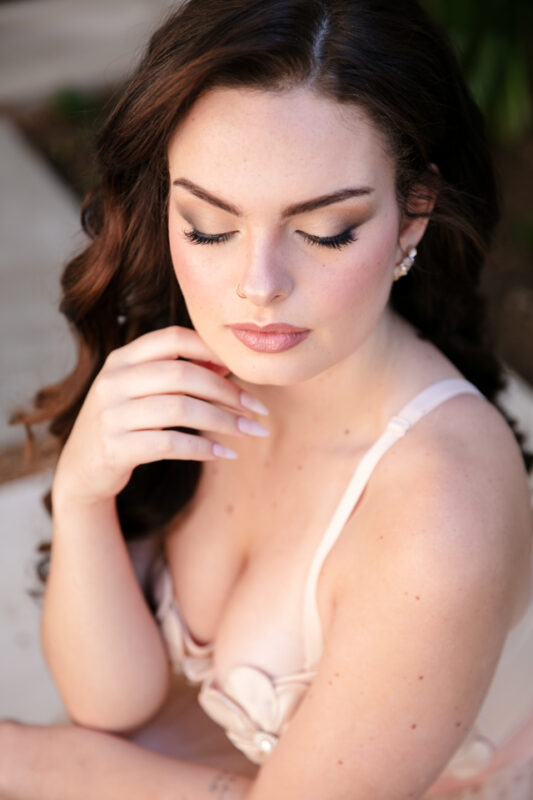 Elegant bridal makeup with soft glam eyeshadow, flawless skin, and a natural pink lip for a wedding day look