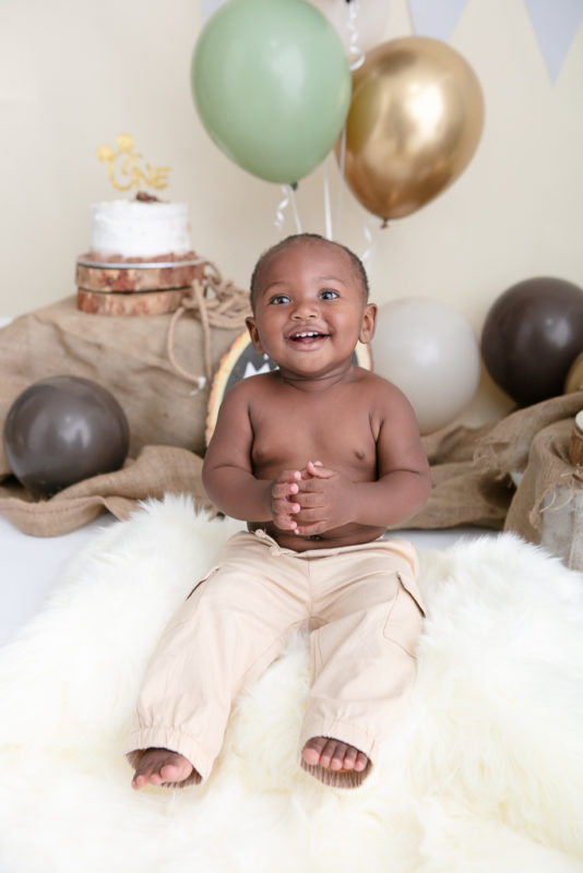 Older brother laughing during his earth-toned Cake Smash Nelspruit birthday session.