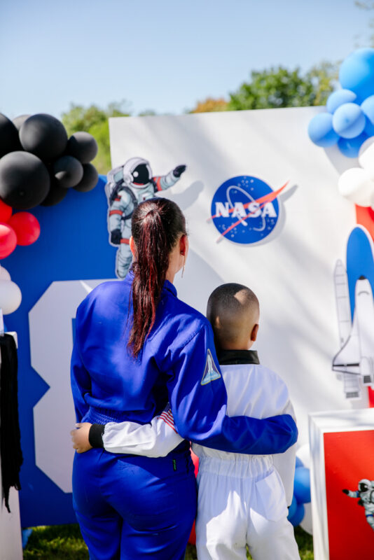 Mom and kid admiring NASA themed decor for party in Mbombela