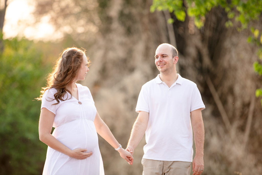 Expecting couple walking hand in hand during outdoor maternity shoot in Nelspruit