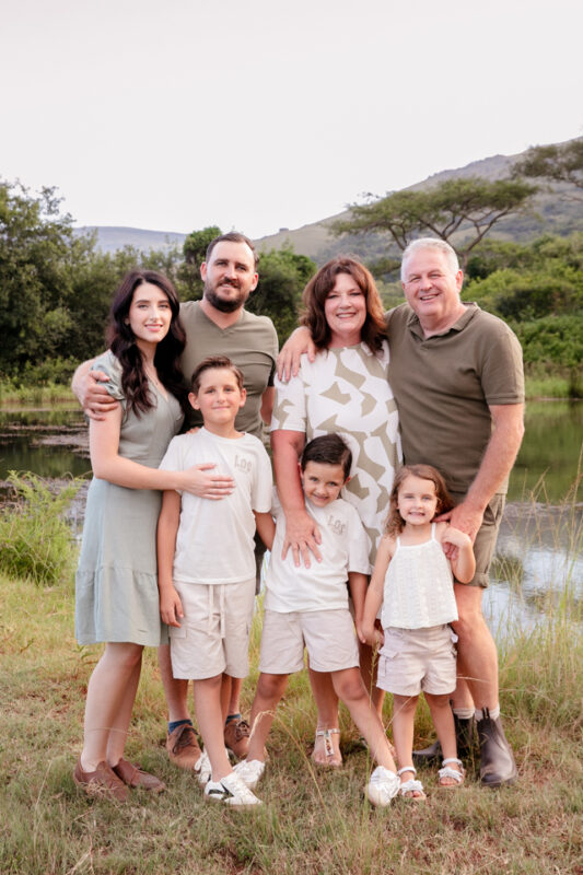 Grandparents standing with their children and grandchildren outdoors