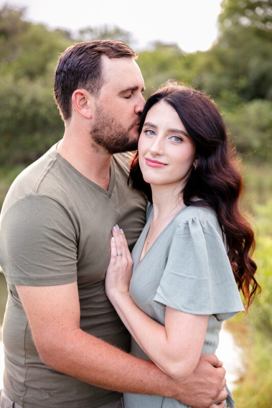 Husband and wife embracing against a beautiful farm background in Nelspruit